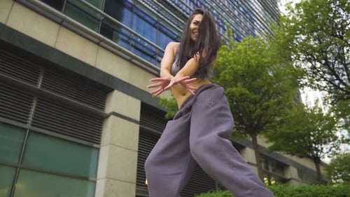 Young Woman Dances in Urban Environment