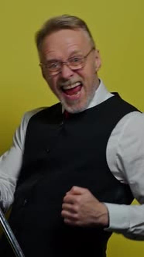 Excited Man Cheering Against Bright Yellow Background