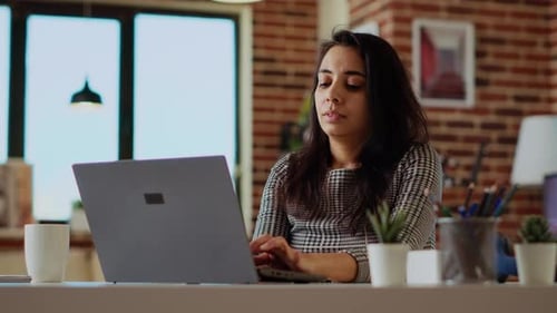 Woman Working on Laptop in Home Office