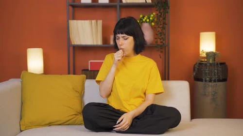 Woman Coughing, Sore Throat on Couch at Home