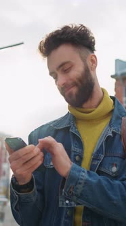 Stylish Man Using Smartphone on City Street