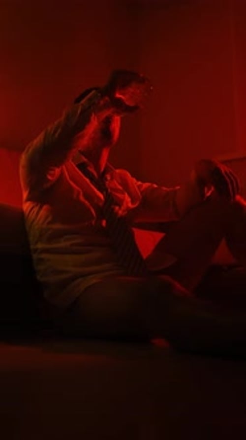 Male Entrepreneur in Shirt and Tie Sits on Floor Home and Drinks Alcohol Night