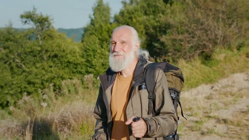 Senior Man Hiking in Green Mountain Landscape
