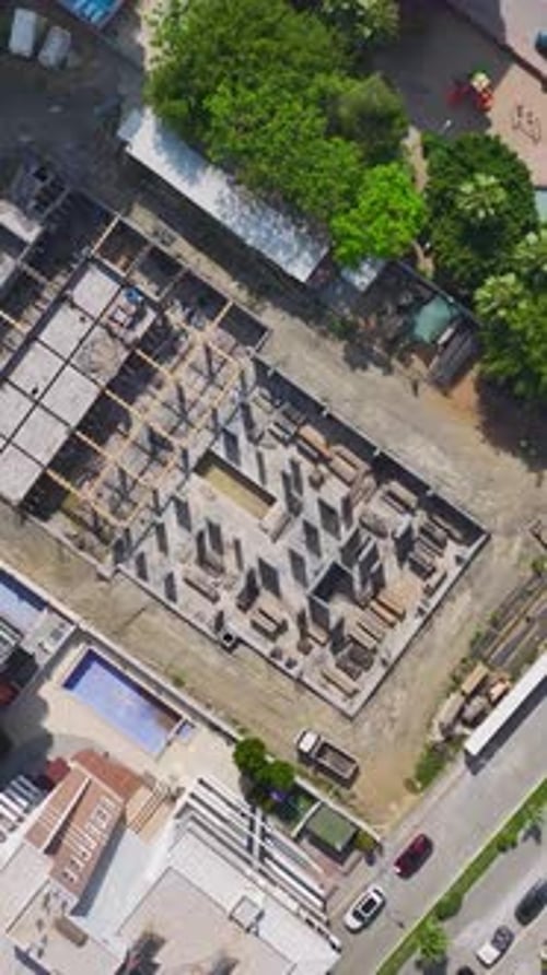 Vídeo vertical: ingenieros y trabajadores cualificados colaboran en la construcción de un nuevo suelo con paredes
