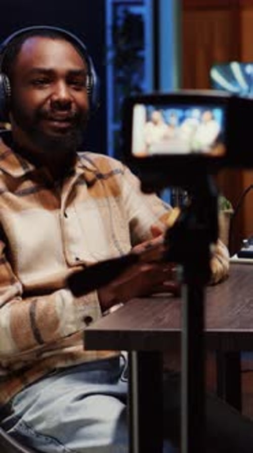 Man Recording Podcast or Vlog with Camera Indoors