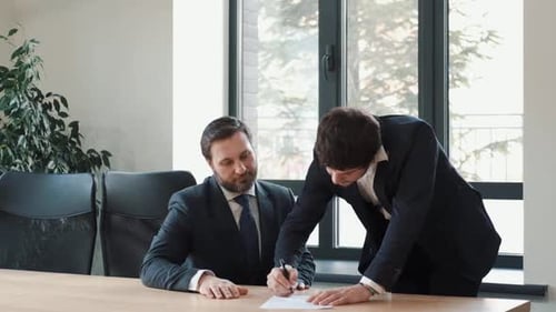 A Man in a Suit a Businessman Shakes Hands with a Colleague Shaking Hands in the Office