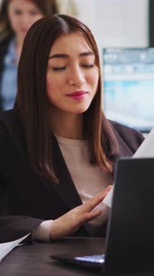 Woman In Office Having a Teleconference
