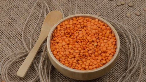 Wooden Bowl of Raw Orange Lentils