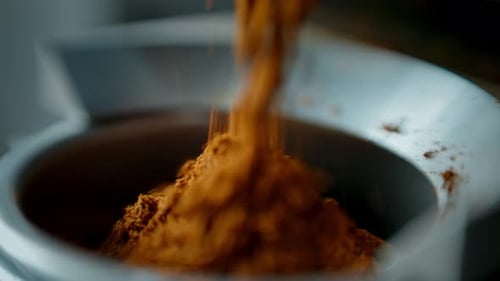 Powdered Ingredient Poured Into White Receptacle