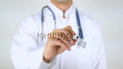 Doctor Writes Happiness on Glass in Studio