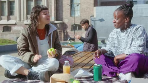 Two Girlfriends Chatting and Having Meal on Campus Picnic