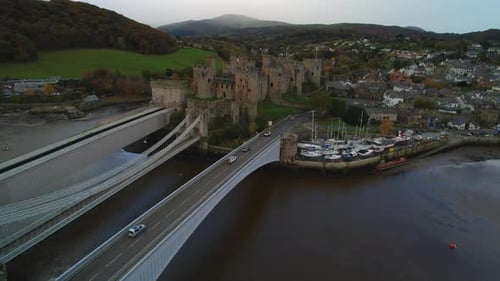 Conwy Castle Ruins - Historic Tourism Landmark in North Wales, UK - Aerial. Drone flying over bridge