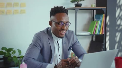 NEW YORK April 5 2020 Happy African American Man Office Worker Sitting at Table and Having Videochat