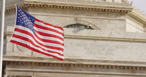 American Flag Waving Beside Marble Building