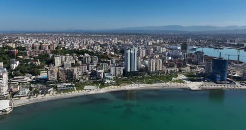 Durres Albania Beachfront with Clear Water and Buildings in Aerial Orbit