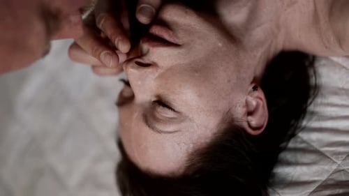 Ein emotionales Porträt eines verliebten Paares, in dem ein Mann sanft das Gesicht einer Frau streichelt, was vermittelt