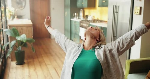 Woman Stretching Arms Reaching Upward Inside Home