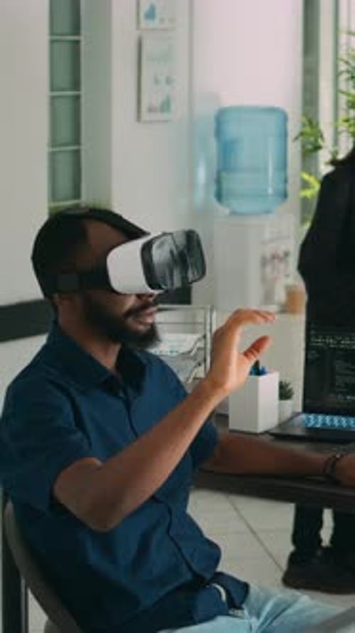 Vertical Video Male App Developer Using Virtual Reality Glasses to Code New Server Interface