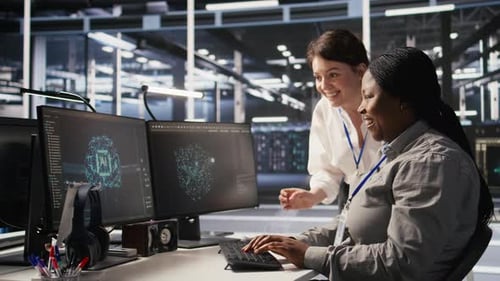 Cheerful Data Center Technicians Collaborating on AI Automation Deployment