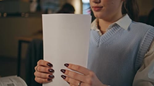 Young Adult Stamping Documents in Office
