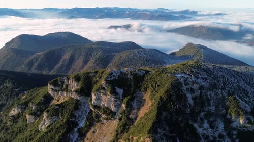 Aerial View of Mountainous Landscape with Forests Valley Full of Fog