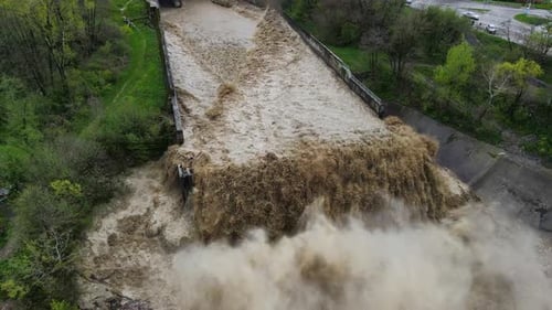 Aerial a Spillway with a Powerful Flow of Rainwater and a Fountain of Spray