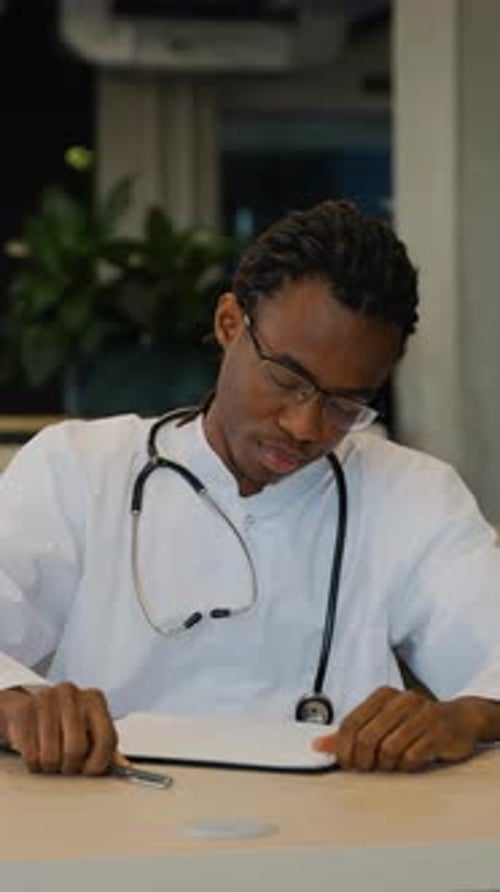 Stressed doctor at his desk in a hospital