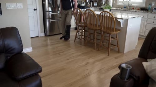 Man Walks Indoors with Crutches and a Boot