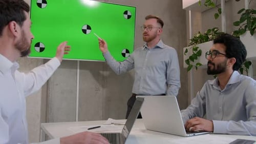 Team Reviews Green Screen Display in Office