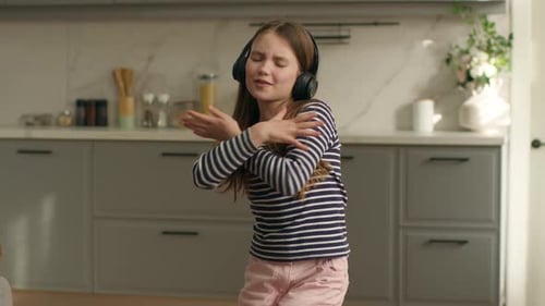 Girl with Headphones Dancing at Home