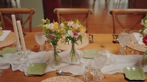 Wedding Table Setting with Floral Arrangements and Candles