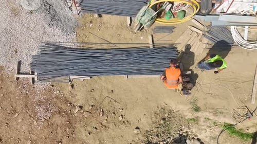 Aerial View Workers Building LoadBearing Walls and Floor Systems at a Site