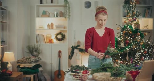 Woman Preparing Christmas Wreath Garland For Christmas Holidays