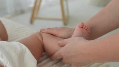Hands Massaging Leg and Foot of Baby