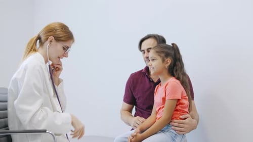 Doctor Examining Young Girl Patient in Clinic