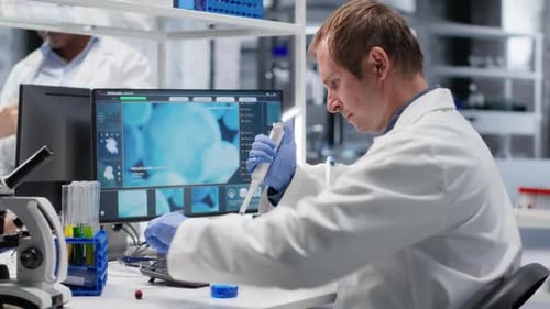 Scientist Working in Laboratory Using Micro Pipette