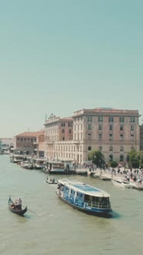 Canal in Venice, Boats and gondolas with tourists float along canal