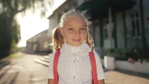 Cute Little Girl in Front of School