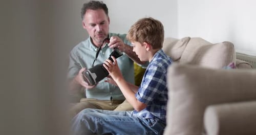 Father and Son Using Virtual Reality Headset Together