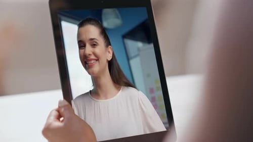Woman Communicating on Tablet Device in Office Setting