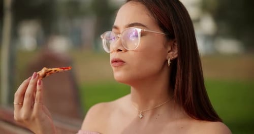 Young Woman Enjoys Pizza Outdoors