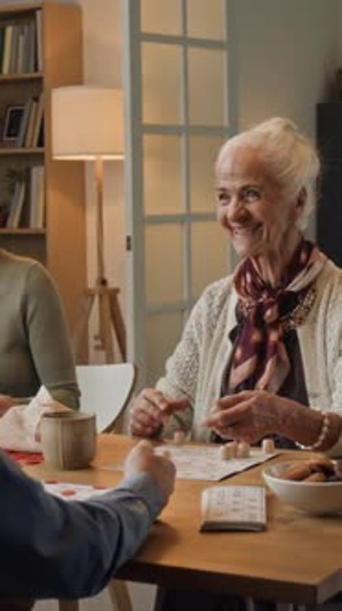 Friends Playing Bingo Together at a Table Indoors
