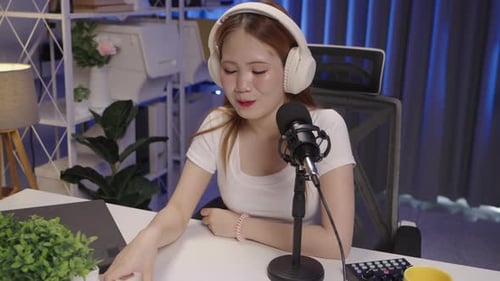 Woman Recording Podcast in Home Studio at Night