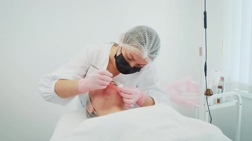Medical Professional Performing a Facial Procedure