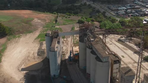 4k Aerial Painted grain silos with city in background Drone overhead medium shot