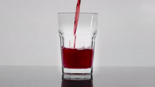 Refreshing Red Liquid Being Poured Into Glass