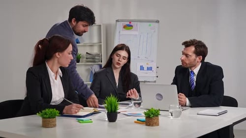 Business Meeting with Four People in Office Setting