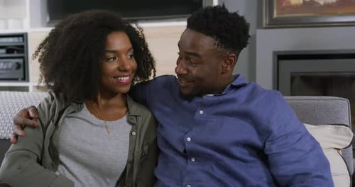 Smiling Couple Relaxing Together at Home