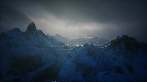 Majestic Mountain Landscape Under a Cloudy Sky During Twilight Hours