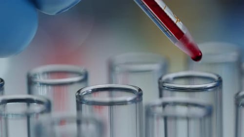 Dropping Blood into Test Tubes in Lab